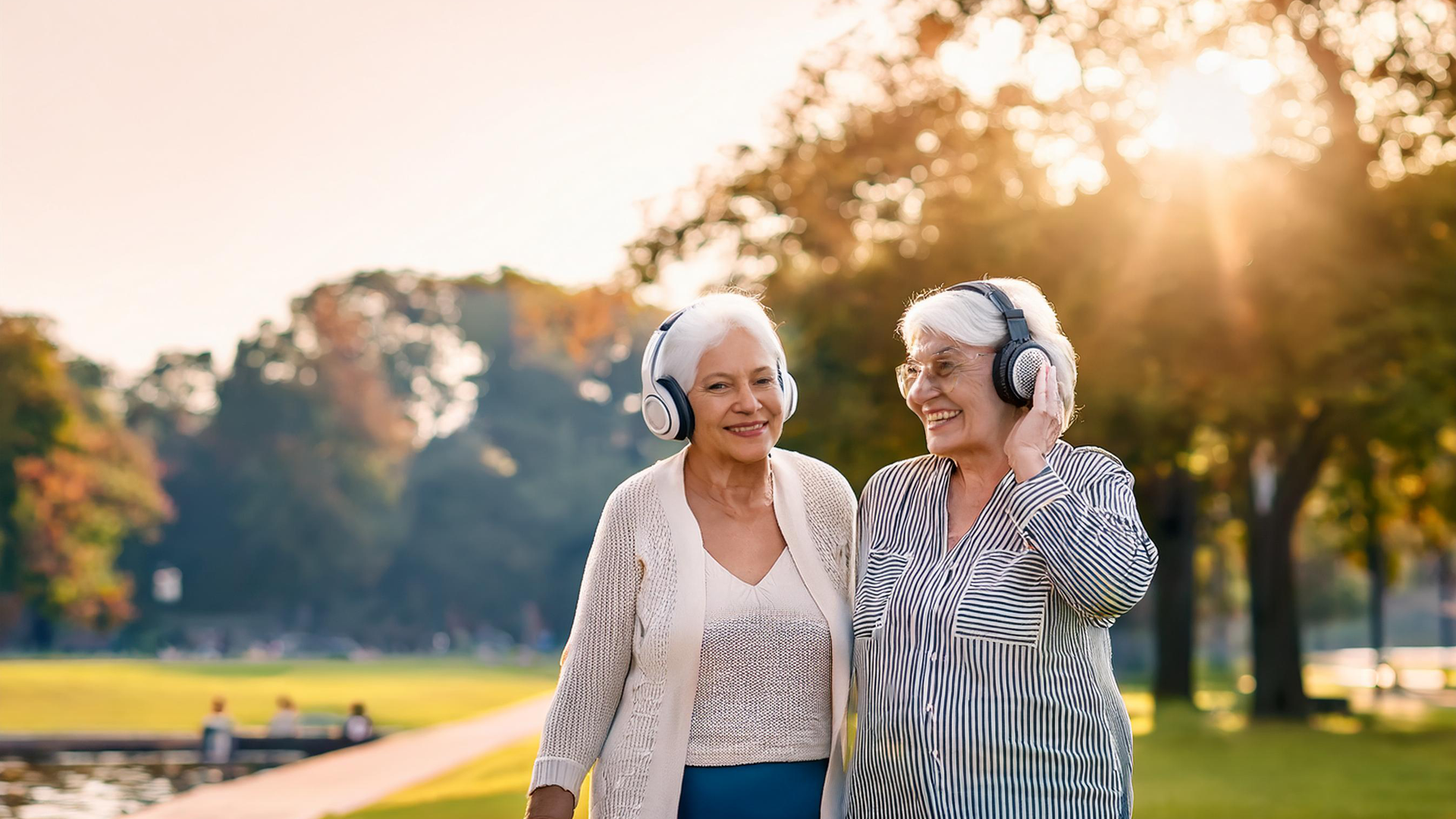 woman in blue sweater using white earbuds